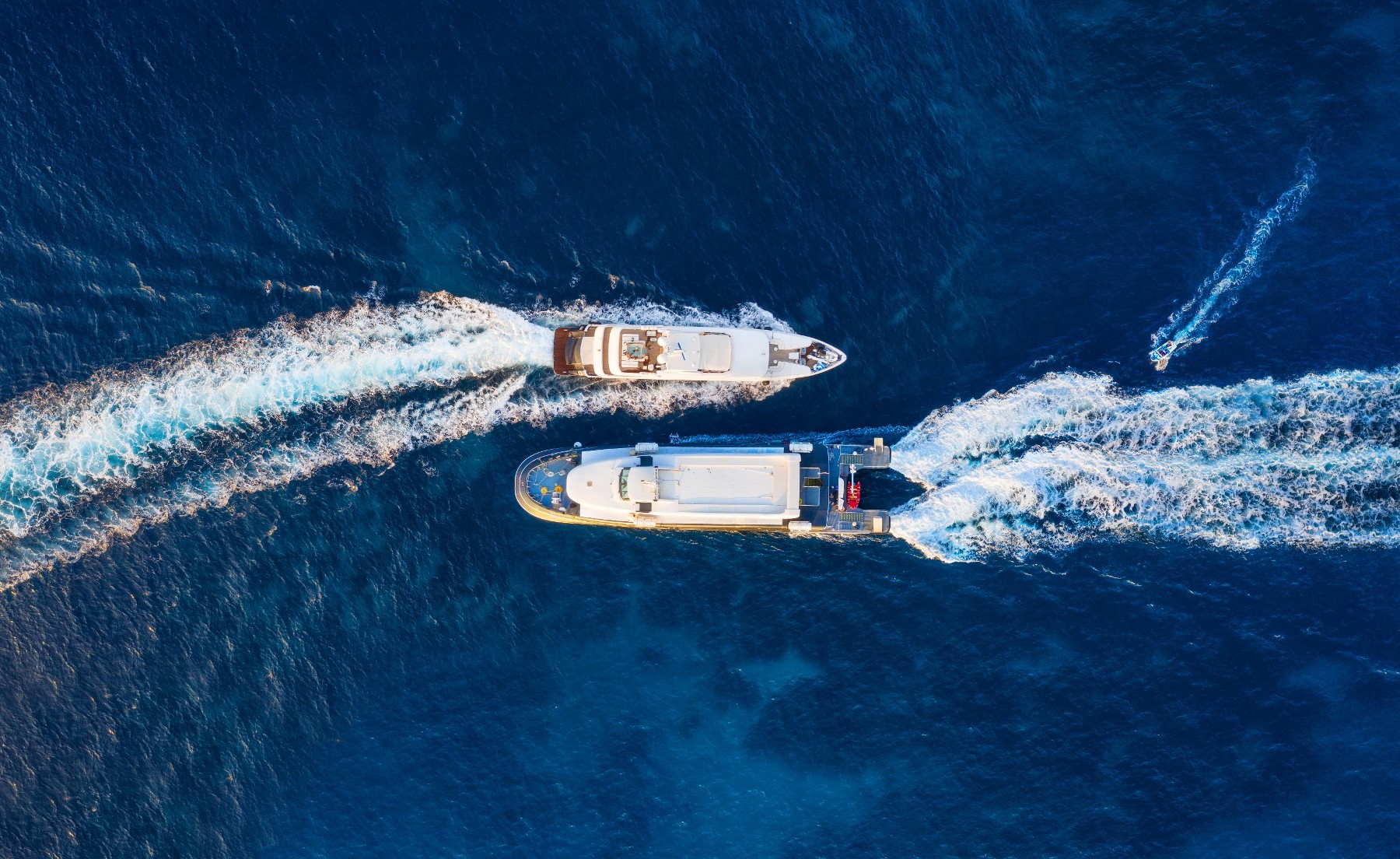 Two yachts crossing paths at sea — logistics and transit