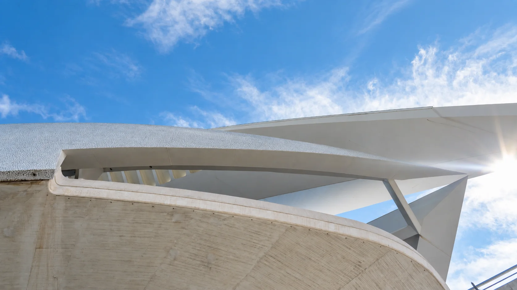 Futuristic maritime architecture beneath a clear blue sky.