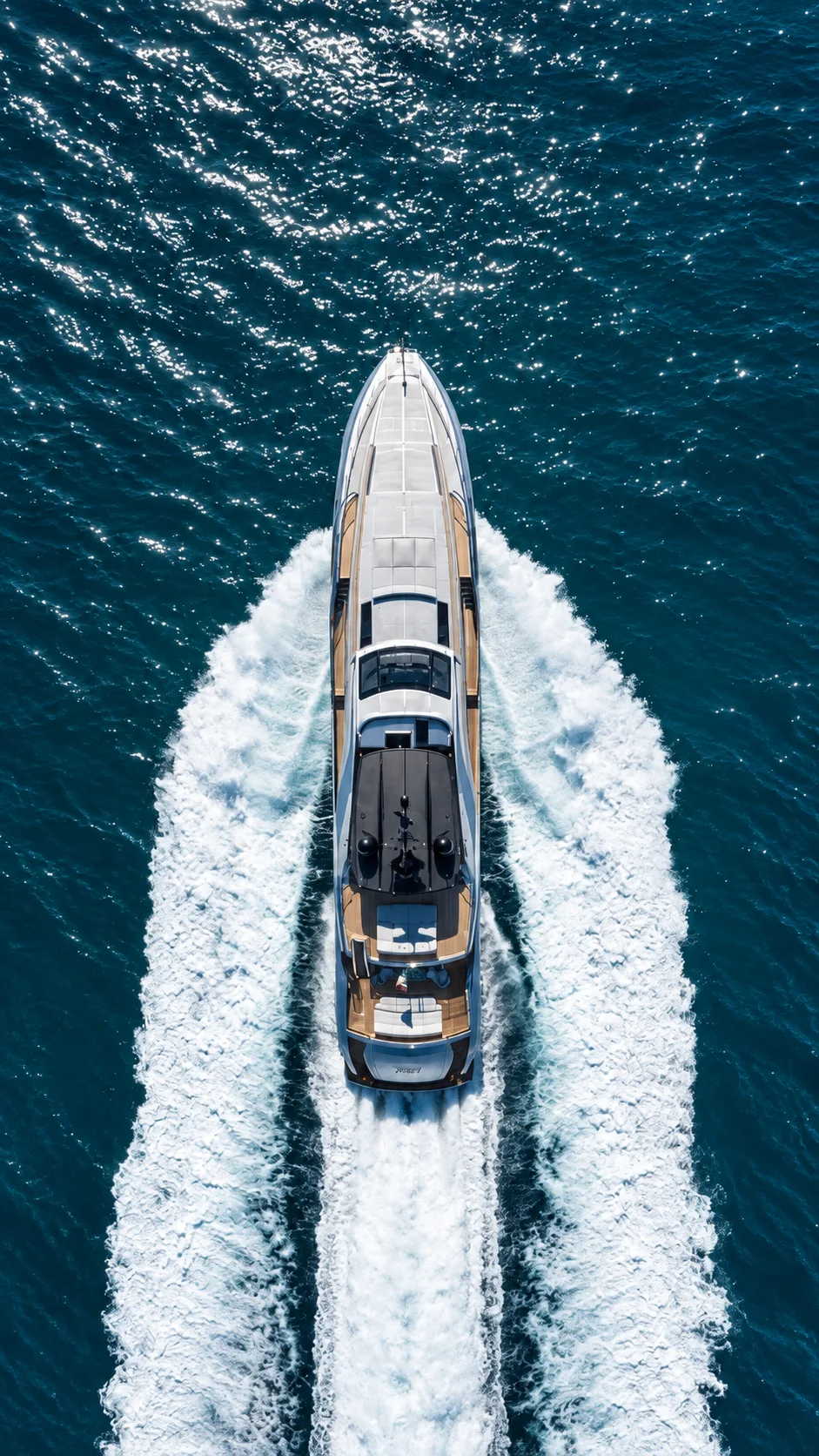 A fast yacht photographed from above while underway.