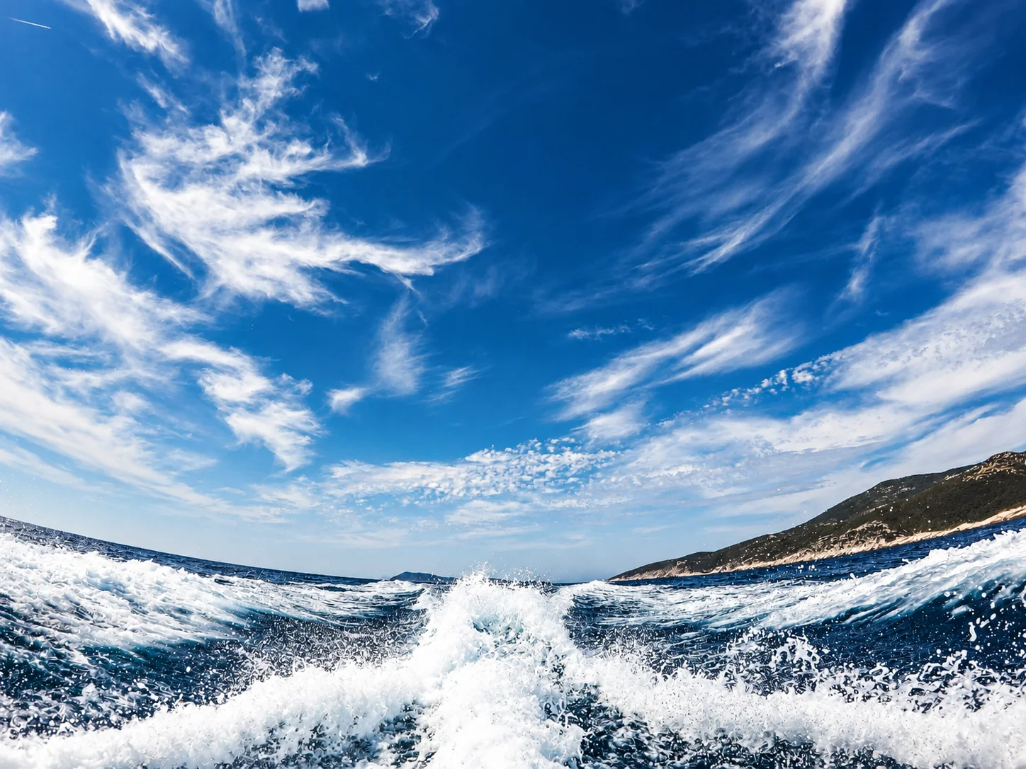 A yacht wake extending towards the horizon.