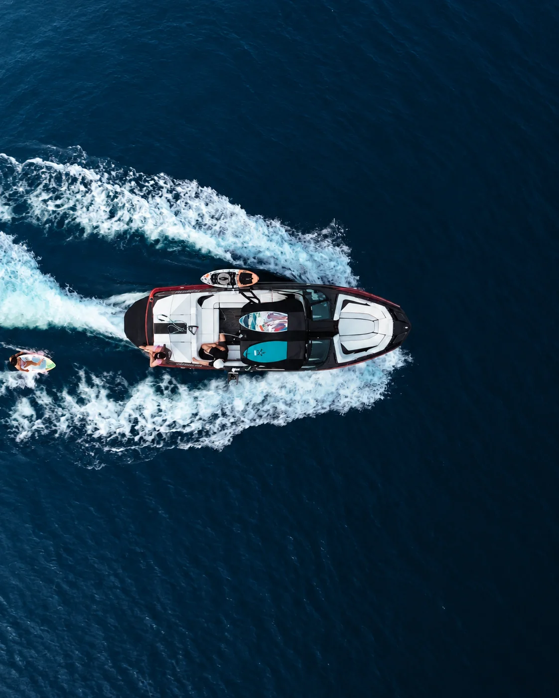 A fast motorboat cutting through deep blue water.