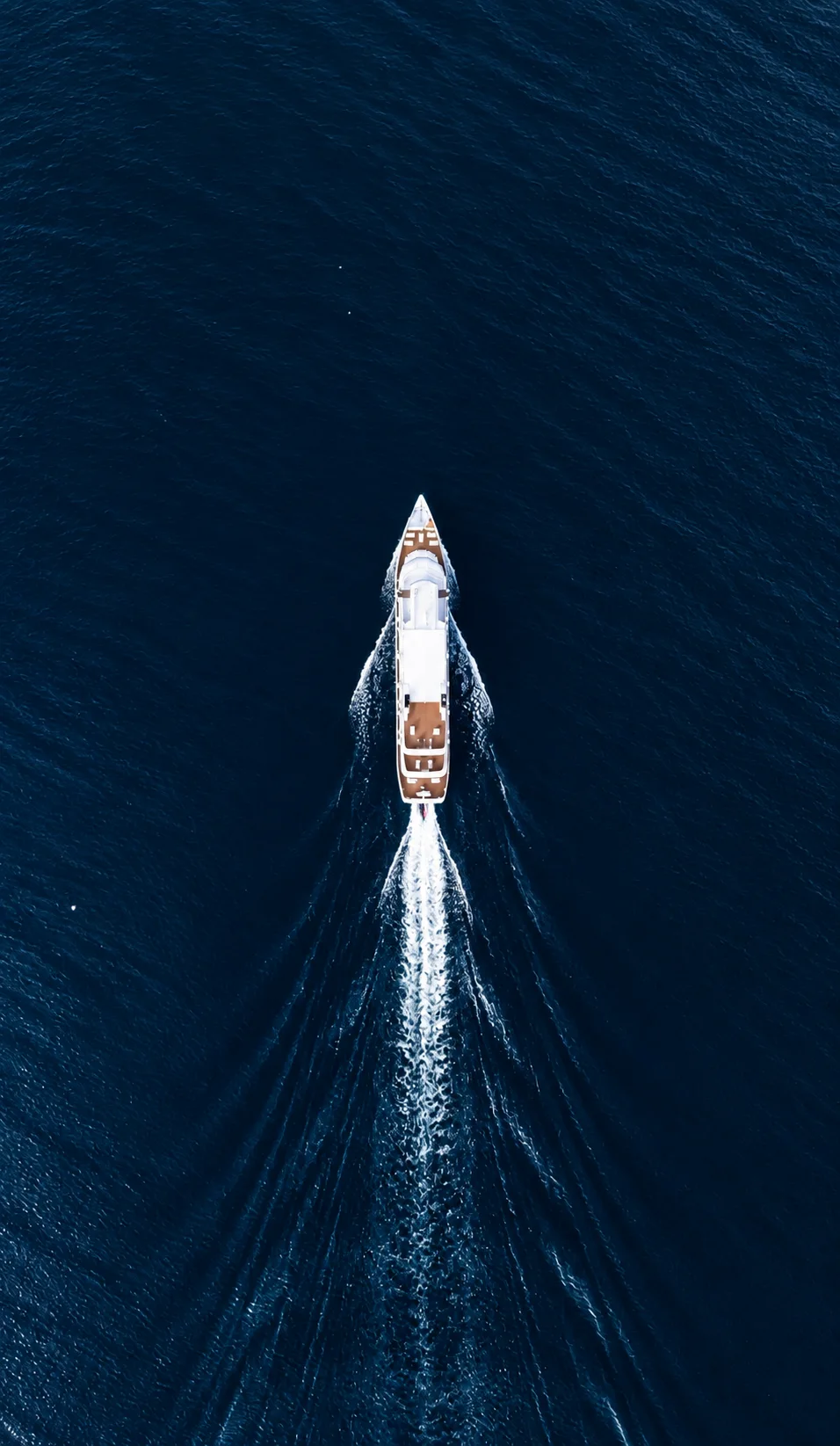 A yacht surrounded by the deep blue of the open ocean.