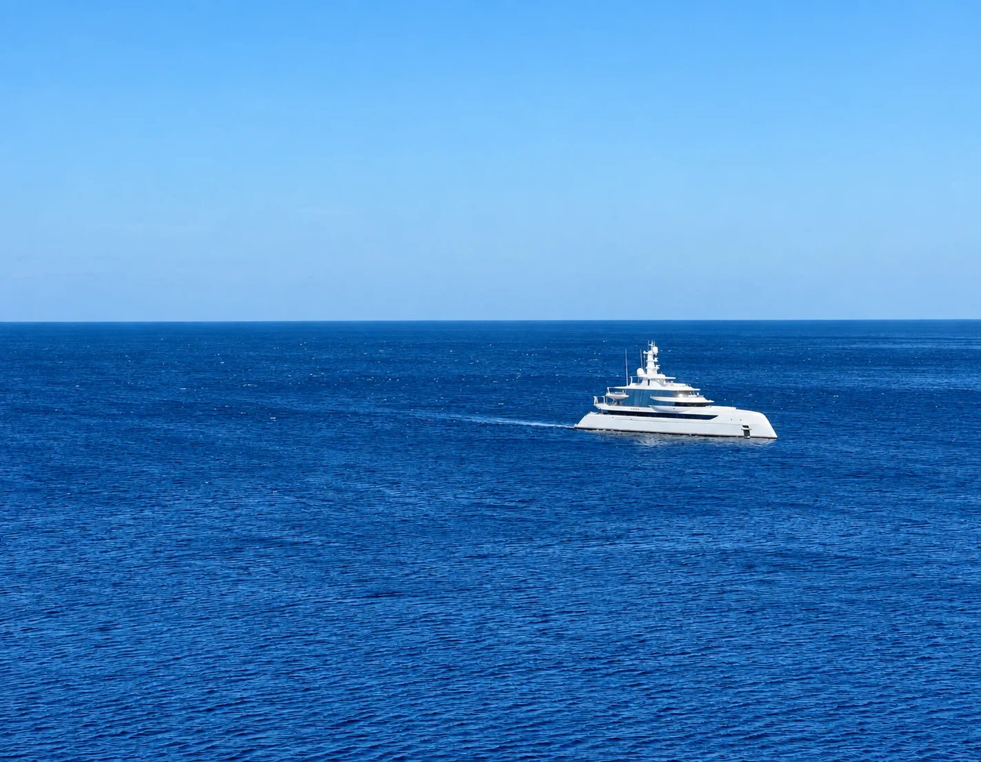 A white yacht underway in open water.