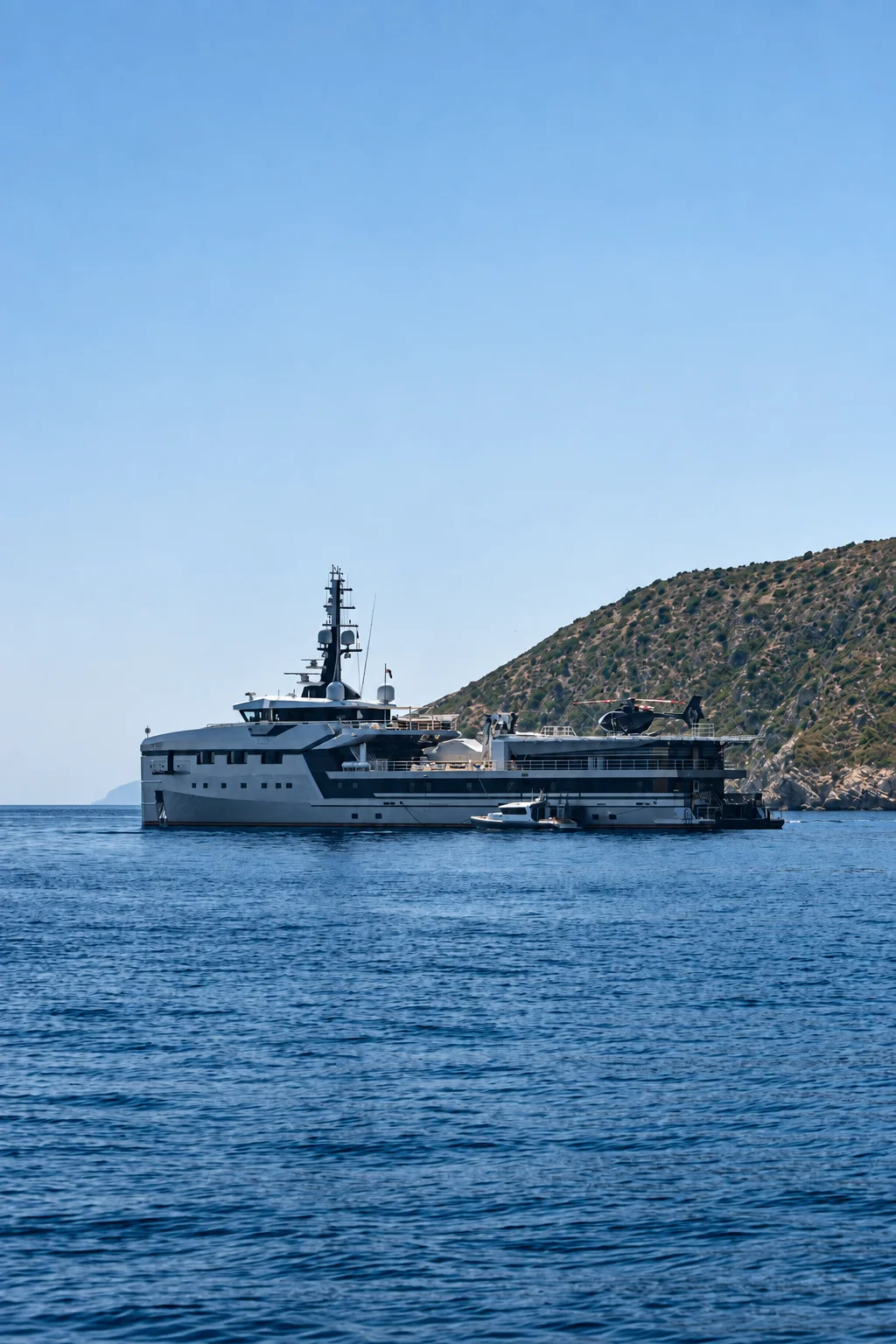 An expedition yacht cruising near a rocky coast.