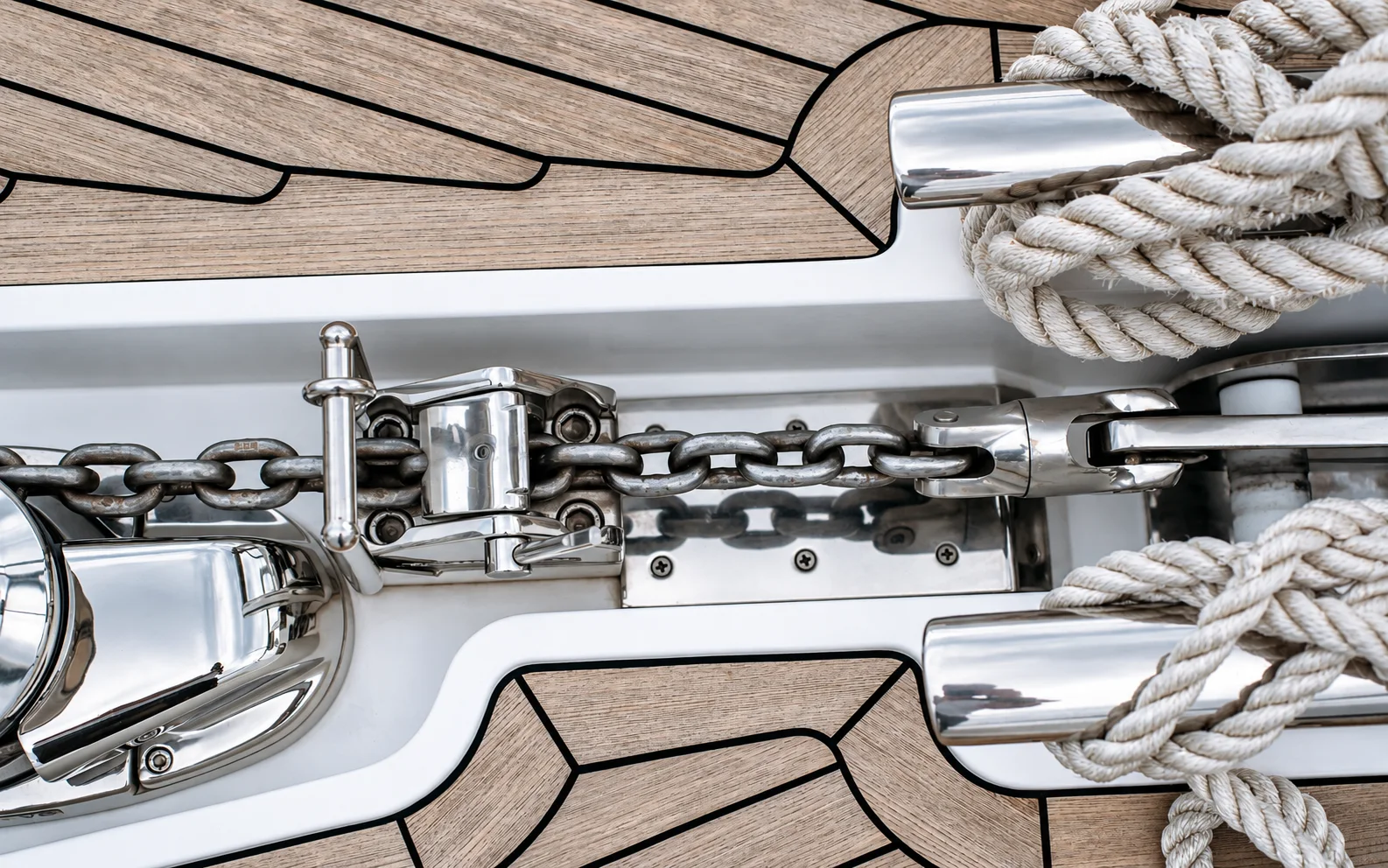 An anchor chain and deck hardware aboard a yacht.