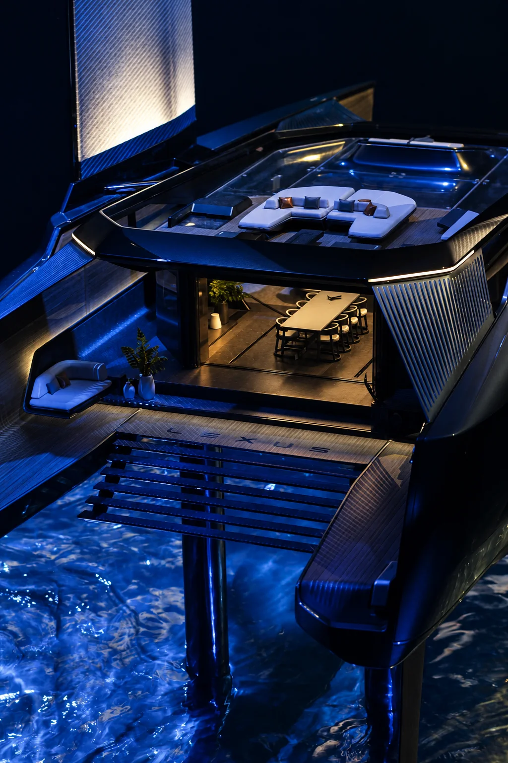 A luxury yacht terrace illuminated at night.