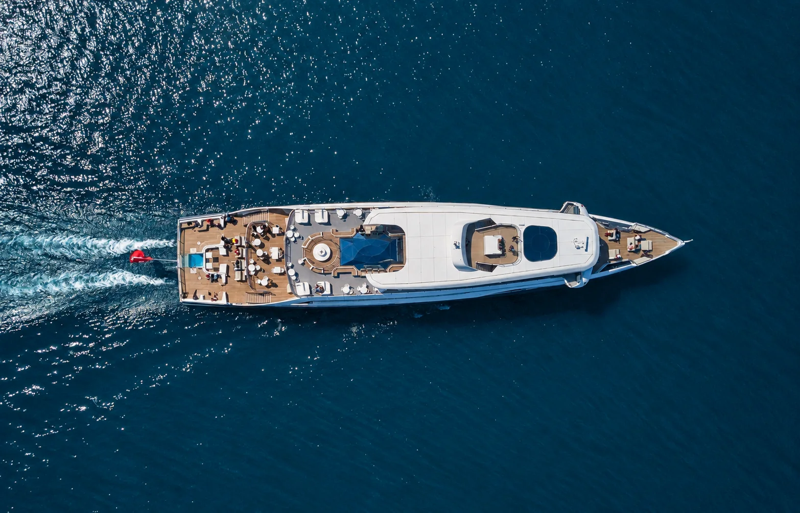 A yacht seen from above in open water.