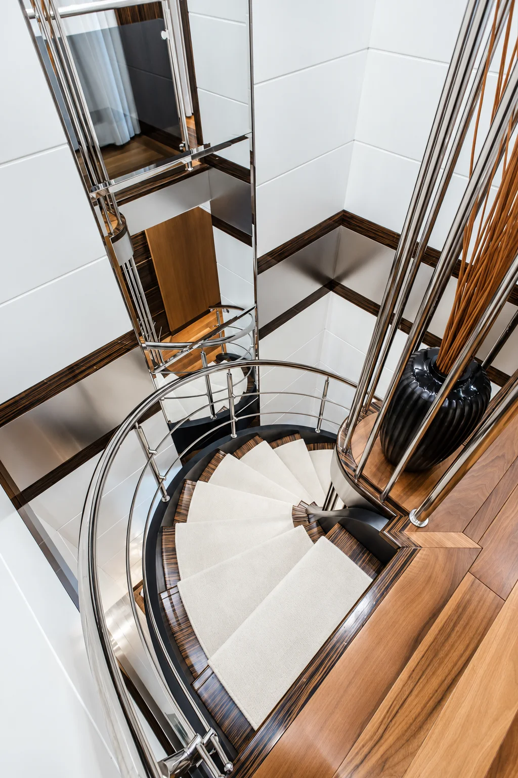 A sculptural spiral staircase inside a yacht.