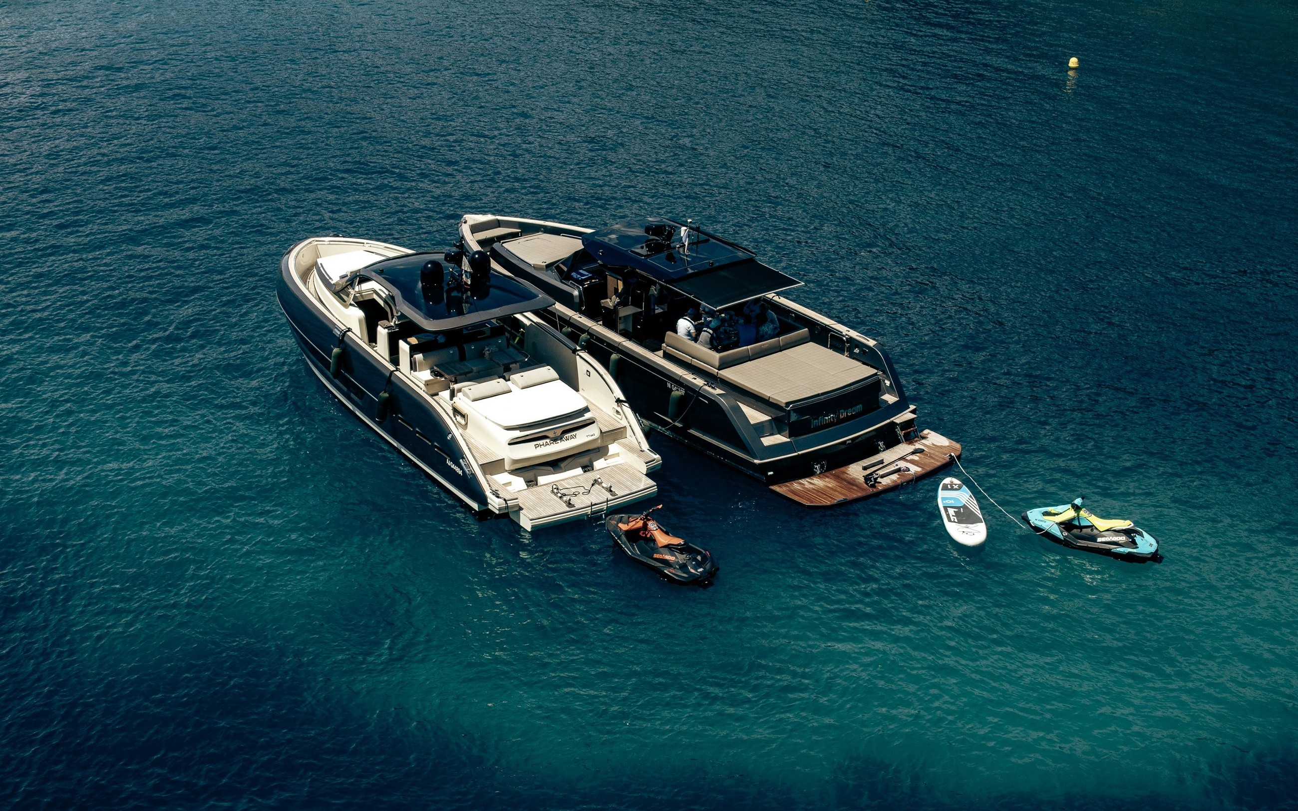 Modern yacht with water toys at anchor